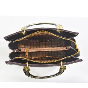 Interior view of black crocodile pattern tote showing spacious compartments and brown lining