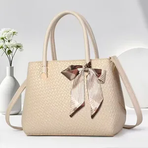 Elegant beige textured handbag with striped scarf detail and detachable shoulder strap