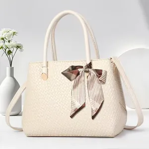 Elegant beige woven texture handbag with silk scarf bow and crossbody shoulder strap