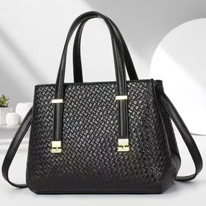 Elegant black woven leather tote bag with gold hardware and adjustable strap for women