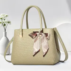 Pistachio green woven textured tote bag with striped silk scarf and long shoulder strap
