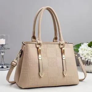 Detail of beige tote bag featuring textured 4G logo embossing and gold-tone hardware accents