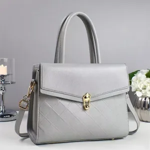 Gray quilted crossbody handbag for women with gold twist lock and adjustable strap