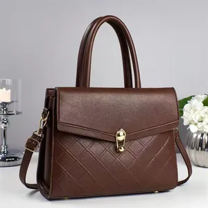 Dark brown leather crossbody bag with quilted panel and golden twist lock closure