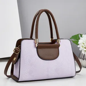 Chic lavender handbag with snakeskin texture and dark brown leather trim with handle