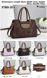 Detailed view of embossed textured women's handbag with dimensions 30x13x20cm and handle detail