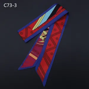 Close-up of geometric pattern silk twilly scarf with red and blue scroll motifs