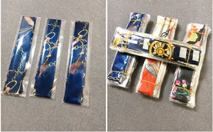 Detailed view of printed slim scarves in OPP bags and wholesale bundles of 20 units