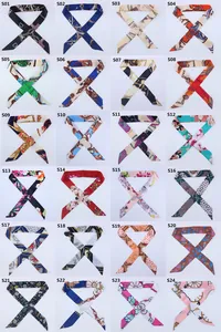 Grid display of 24 colorful patterned satin skinny scarves for handbag handle decoration