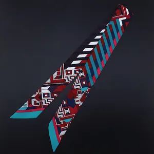 Macro detail of geometric patterned skinny silk scarf in vibrant red and navy blue tones