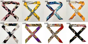 Detail view of eight printed narrow twilly scarves featuring chain and leopard patterns