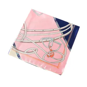 Detail of silk-like square scarf featuring equestrian chain and leather belt patterns