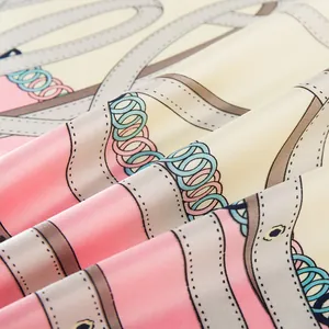 Macro shot of 90cm silk-like scarf featuring chain patterns and twill weave texture