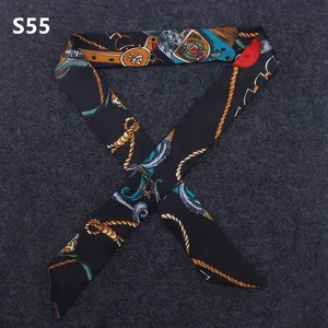 Detail of equestrian print narrow silk scarf wrapped around a bag handle