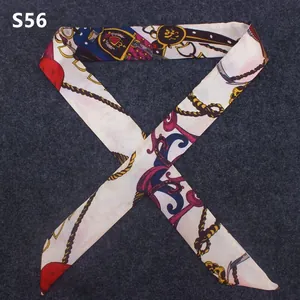 Macro view of slender twilly scarf featuring equestrian motifs and vintage chain patterns
