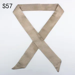 Detailed texture of champagne satin skinny scarf with elegant black polka dot pattern