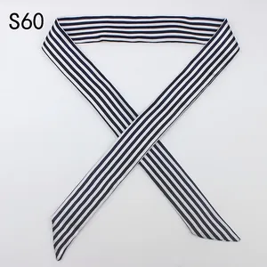 Detail of a long black and white striped twilly scarf with a smooth satin finish texture