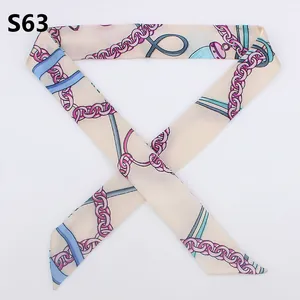 Detailed view of cream silk-like twilly scarf with purple chain and light blue ribbon pattern
