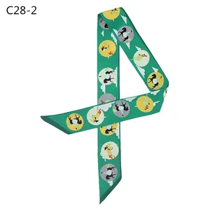 Detail of silk-like dark green twilly scarf featuring elegant carousel print pattern