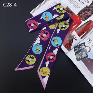 Close-up of a purple silk twilly scarf with equestrian print on a fashion magazine