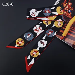 Close-up of vintage horse carriage pattern on a narrow satin scarf with red border