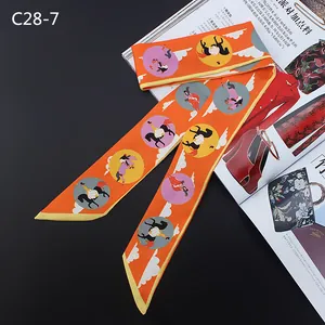 Detail of orange equestrian silk scarf tied elegantly next to a fashion magazine