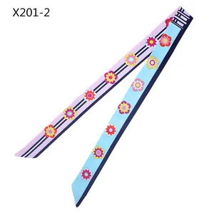 Detail of a 120cm floral twilly scarf with pink and blue sides and delicate flower patterns
