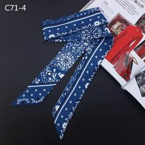 Detail of dark blue bohemian silk twilly scarf with white mandala patterns and satin finish