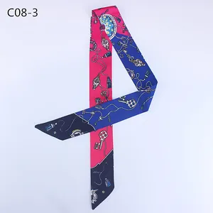 Detail of vintage key print silk scarf with navy blue and rose red patchwork design
