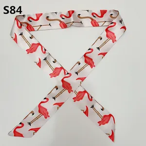 Detail of silk twilly scarf S84 with red flamingo pattern for bag handle decoration