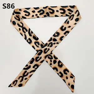 Macro detail of leopard print twilly scarf with elegant pointed ends and satin texture