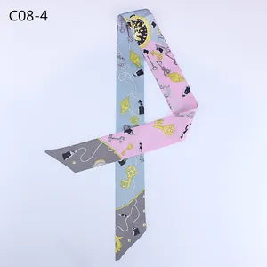 Pink and blue silk-like twilly scarf featuring elegant gold key and chain patterns