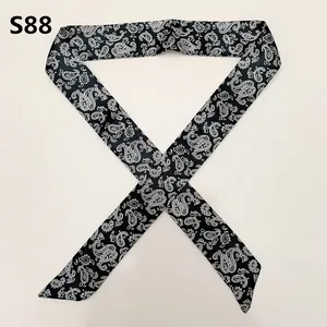Macro shot of S88 black silky ribbon scarf with white paisley pattern for handbags