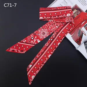 Detail of red Bohemian style silk twill skinny scarf with paisley floral pattern