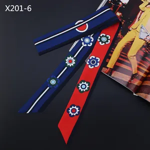 Detailed view of long floral satin ribbon with navy blue and red geometric pattern