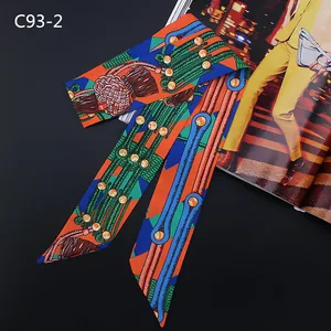 Detailed macro view of silky twilly scarf with chain prints and nautical knot patterns