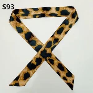 Detail of slim leopard print satin scarf with pointed ends for bag handles