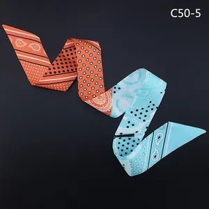 Orange and blue paisley twilly silk scarf with star and polka dot patterns
