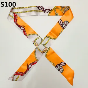 Detail of orange and white twilly silk scarf with vintage equestrian harness chain print