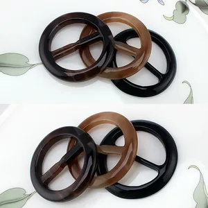Close-up of resin scarf rings in tortoiseshell and amber colors for fashion accessories