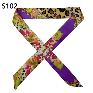 Macro detail of silk feel twilly scarf with floral prints and leopard pattern for bags