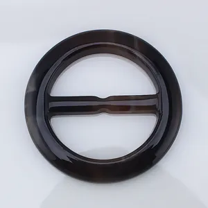 Macro shot of circular tortoiseshell resin scarf buckle with a smooth polished finish