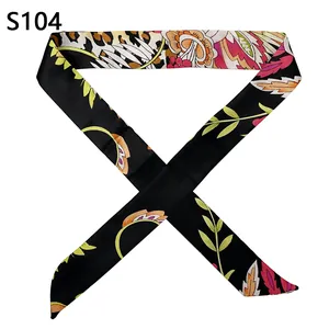 Detail view of a satin twilly scarf with leopard print and tropical floral patterns