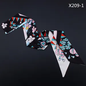 Detail view of a 120cm floral ribbon scarf with pink flowers and polka dots on black