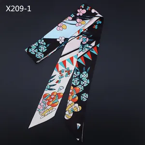 Detail of 120cm floral skinny scarf showing colorful geometric patterns and peach blossoms