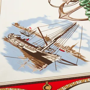 Close-up of nautical silk scarf with vintage sailing boat, anchors and geometric patterns