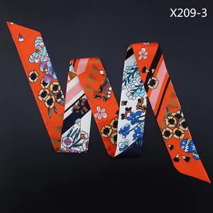 Detailed view of 120cm floral orange silk-like scarf with vibrant geometric patterns
