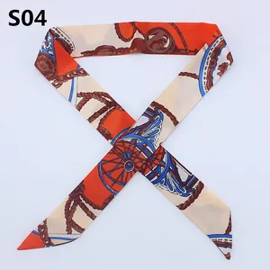 Slim silk twilly scarf with orange carriage wheel pattern for luxury bag handles