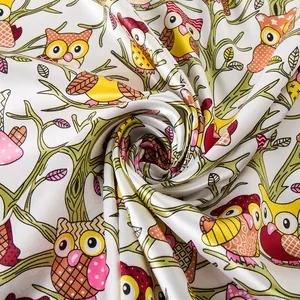 Close-up of vibrant owl pattern on smooth silk-like satin fabric with pearlescent finish