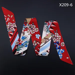 Detail of red floral twilly scarf with blue abstract patterns on black background